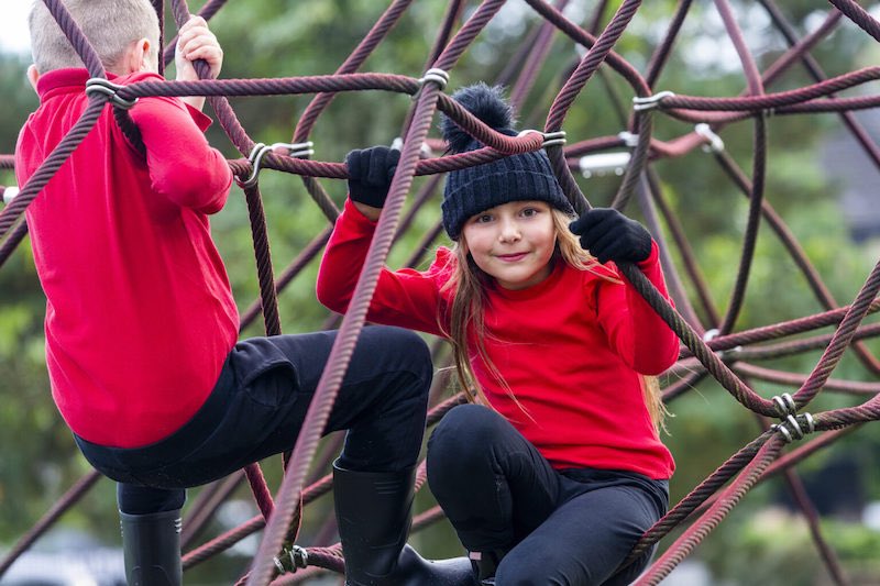Jack and sister Emma playing on a playpark obstacle.
