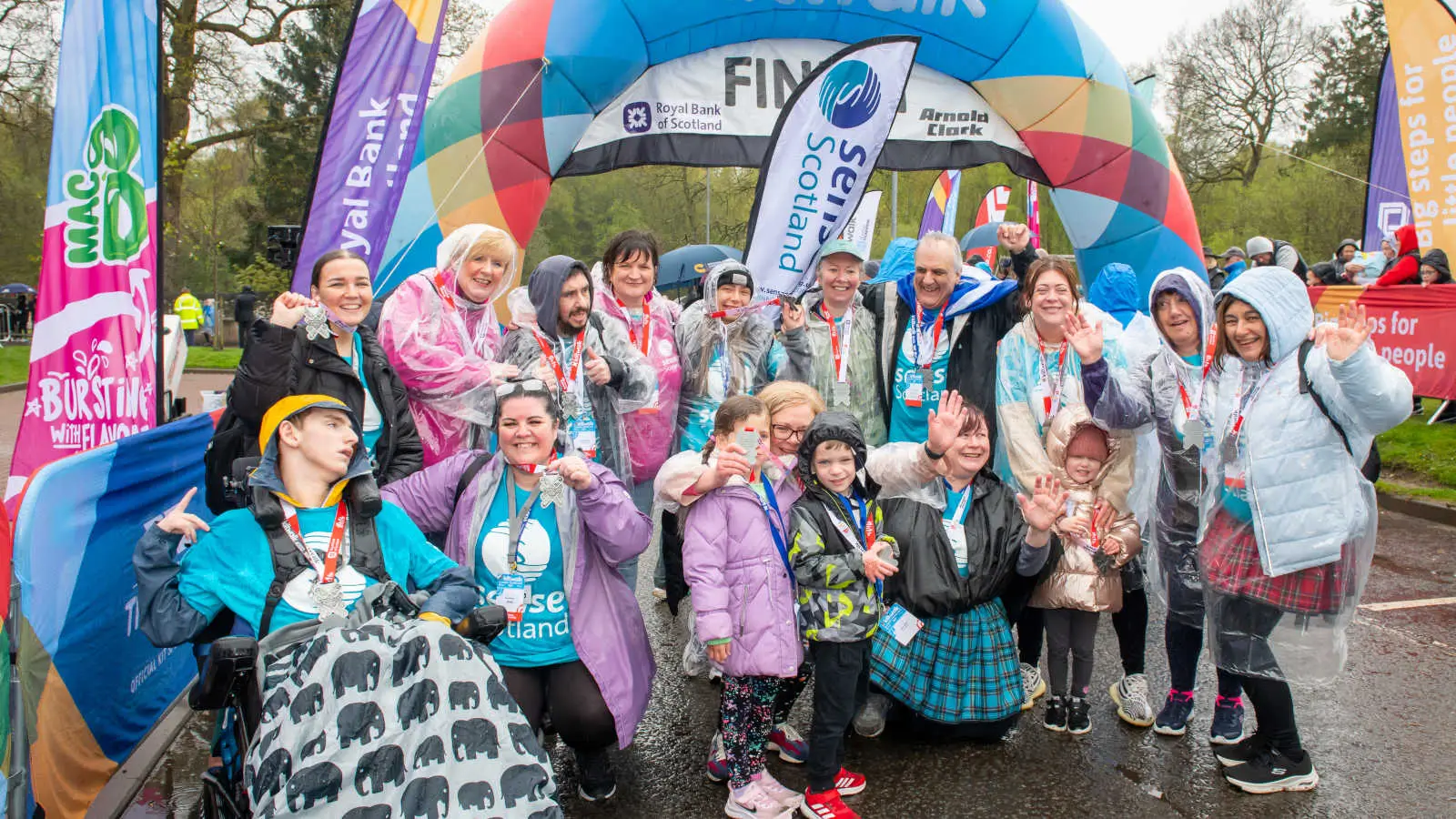 A group of Kiltwalkers celebrating at the finish line. 