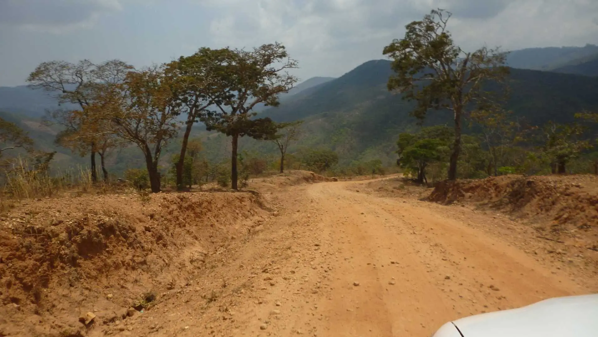 a car drives down a road in malawi