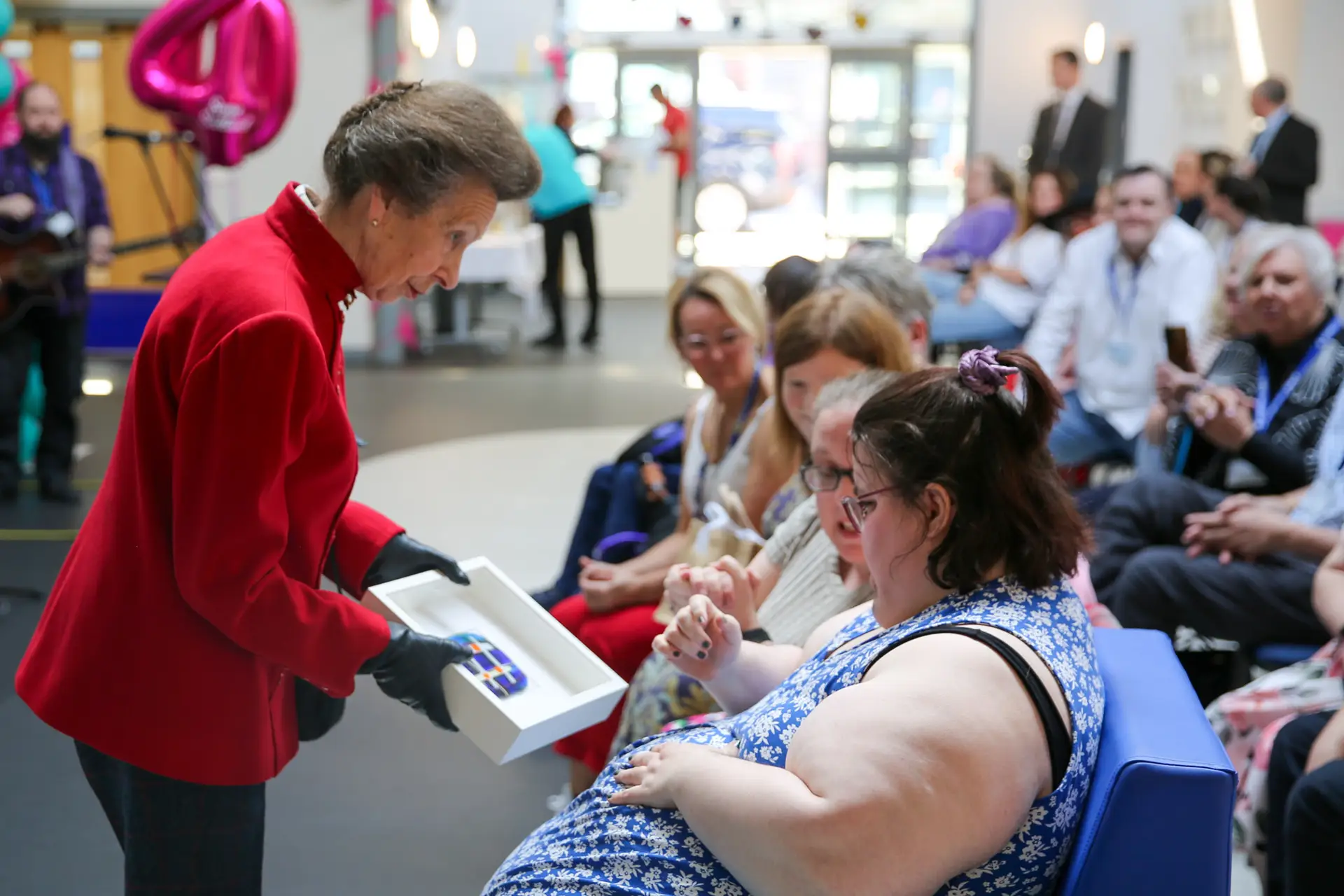 The Princess Royal receives a framed piece of glasswork from one of the people Sense Scotland supports
