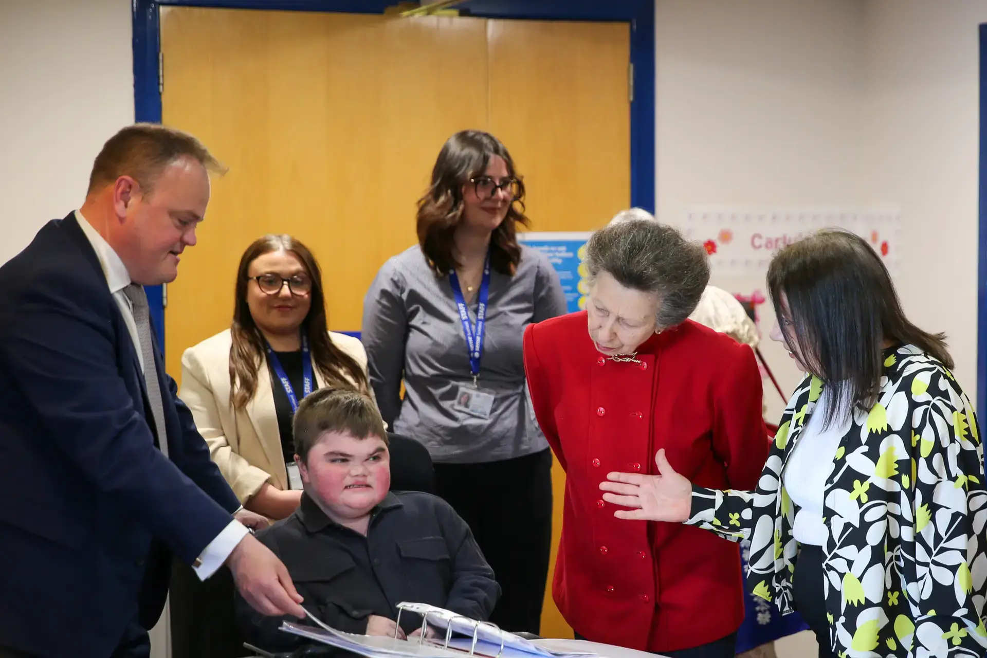The Princess Royal is introduced to a member of Sense Scotland's Learning Hub, accompanied by Sense Scotland staff and the member's father