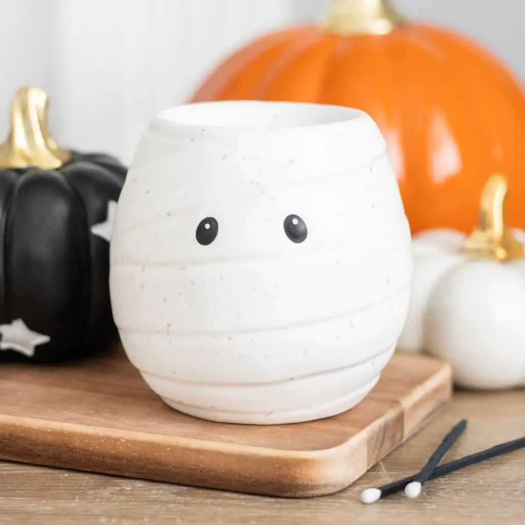Wax melter decoration in shape of a mummy, white